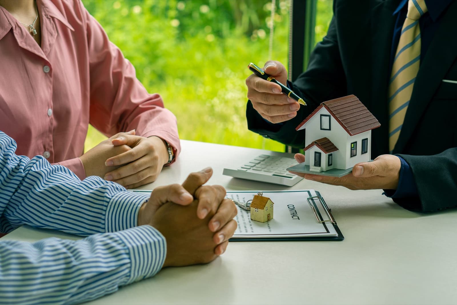 A couple working through their loan questions with a broker